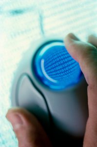 Close-up of a person's hand holding a computer mouse